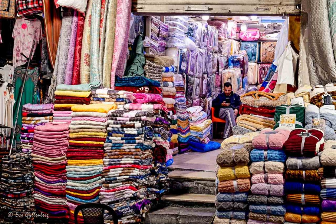 Försäljare av sängkläder och handdukar på en marknad